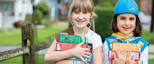 For Cookie Sellers Girl Scouts holding cookie boxes